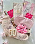 Elegant 60th birthday gift set featuring celebratory items such as a 60th wax melts, luxury chocolates, pampering treats, and a card, beautifully presented in a gift box