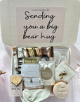 Sending Bear Hugs gift box with a soft teddy socks, comforting treats, and a thoughtful card, all arranged in a cosy package to show love and care.