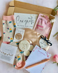 New Job gift box with celebratory treats such as a pen, cookie, socks, stationery, and a congratulatory card, thoughtfully packed to mark a fresh star
