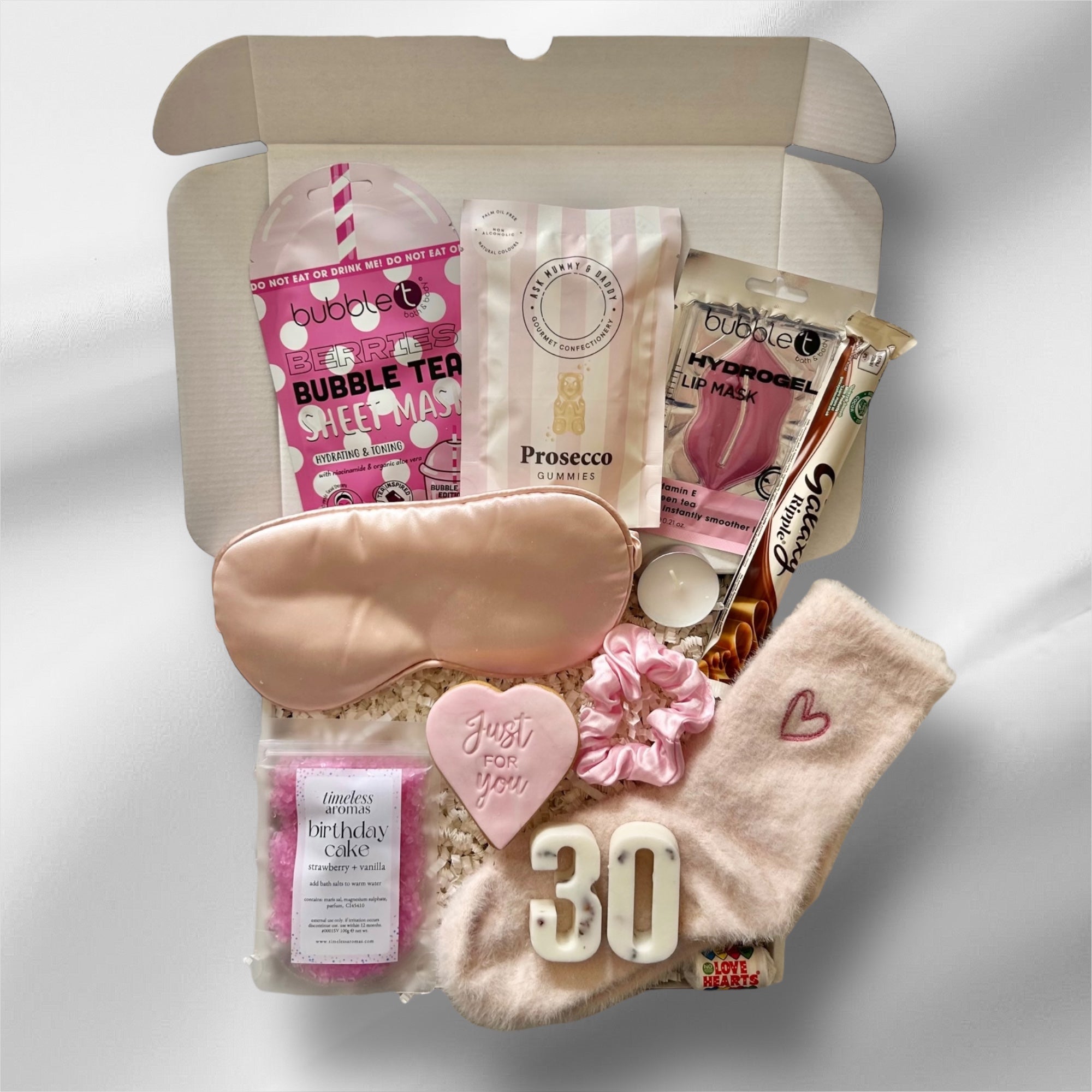 Luxury 30th gift box with soothing face masks, indulgent sweets, premium bath salts, and cosy socks, elegantly packaged for a relaxing and celebratory experience.