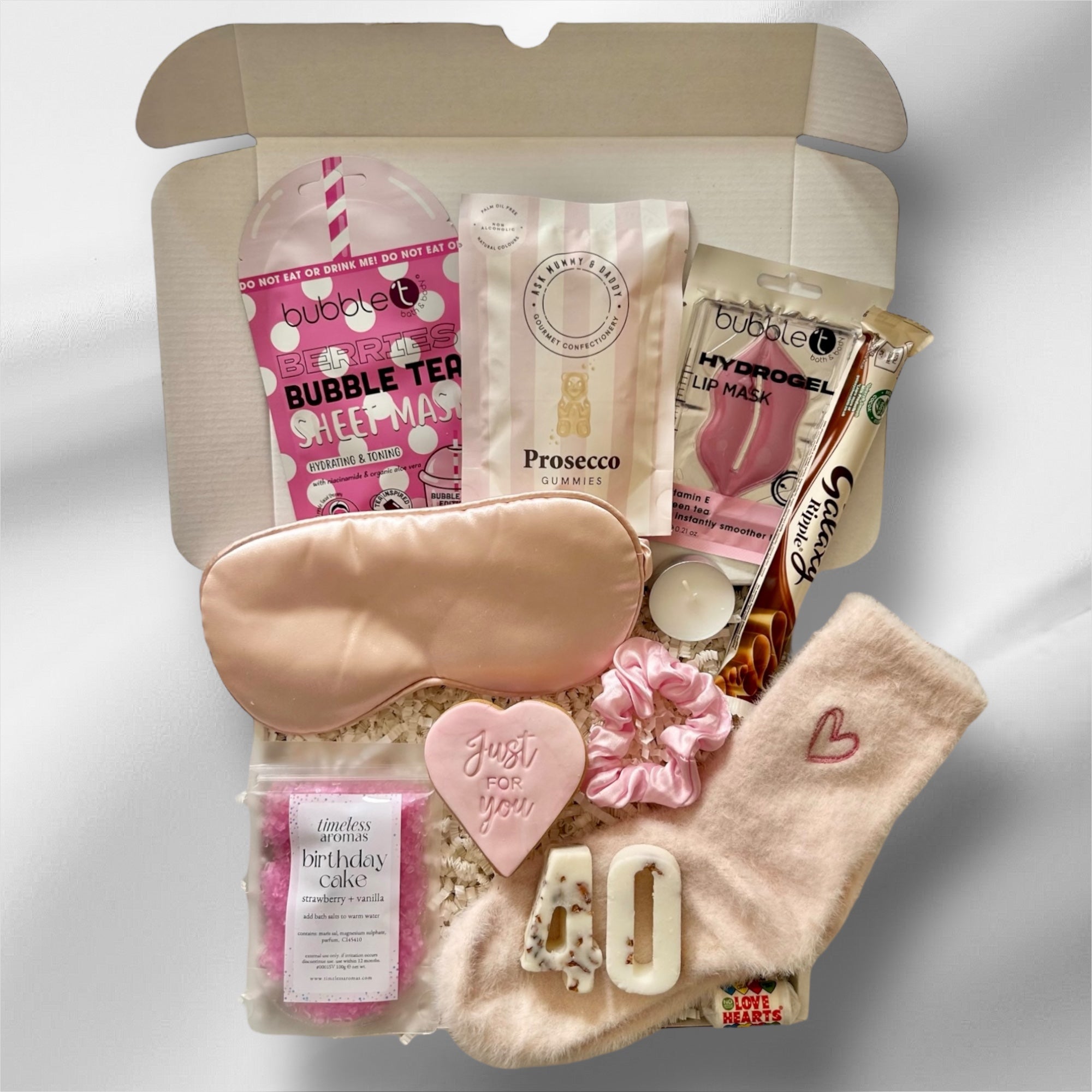 Luxury 40th gift box with soothing face masks, indulgent sweets, premium bath salts, and cosy socks, elegantly packaged for a relaxing and celebratory experience.