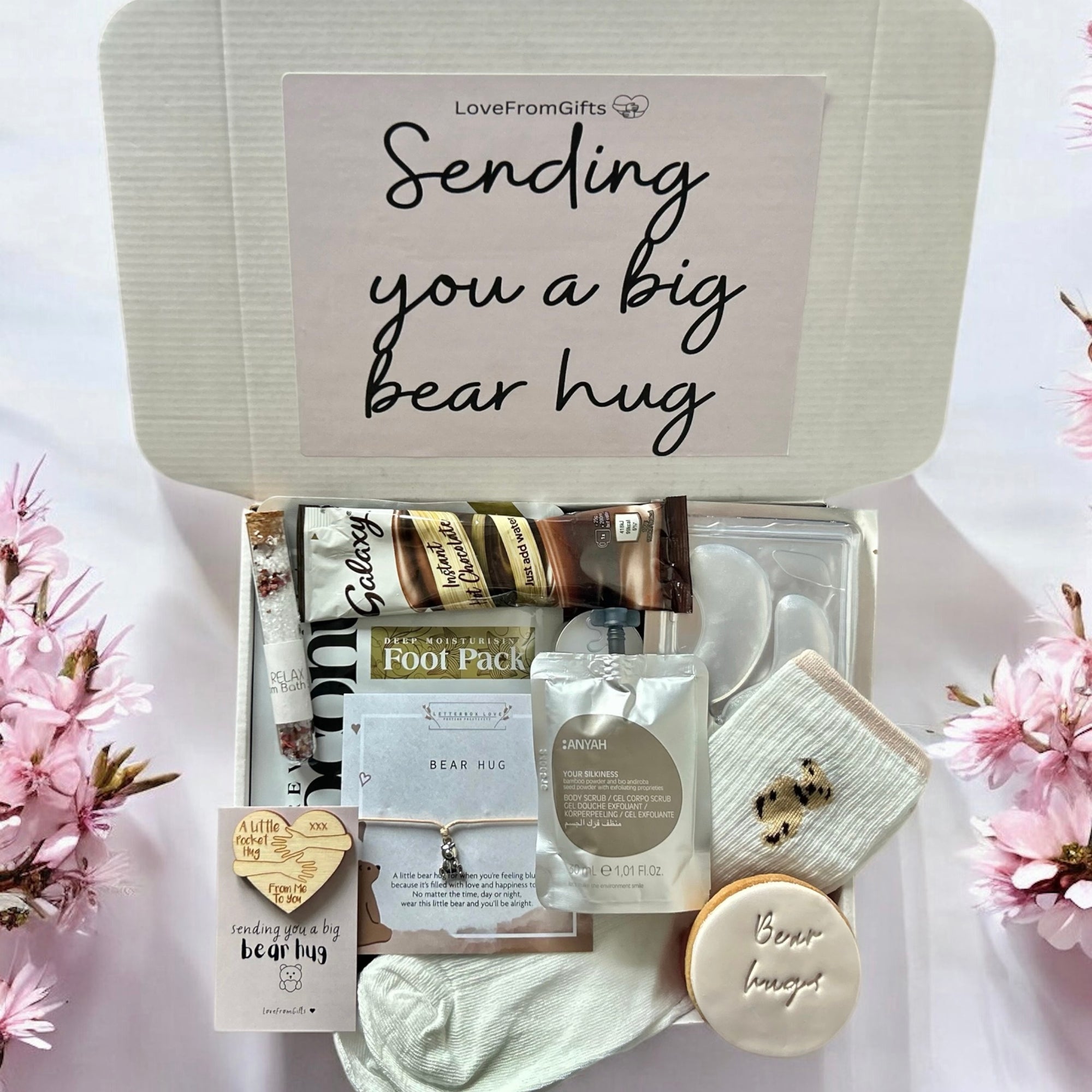Sending Bear Hugs gift box with a soft teddy socks, comforting treats, and a thoughtful card, all arranged in a cosy package to show love and care.