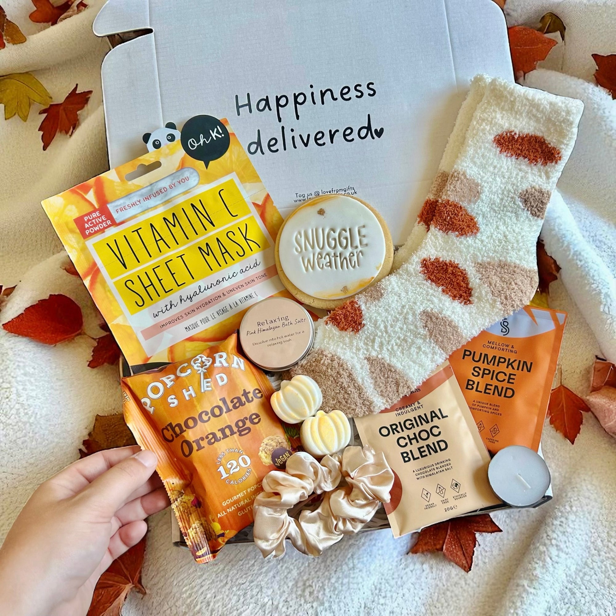 Autumn Snuggle Cosy Gift Box filled with seasonal treats, including delicious popcorn, cookie, hot chocolate mix, a spiced candle, and cosy socks