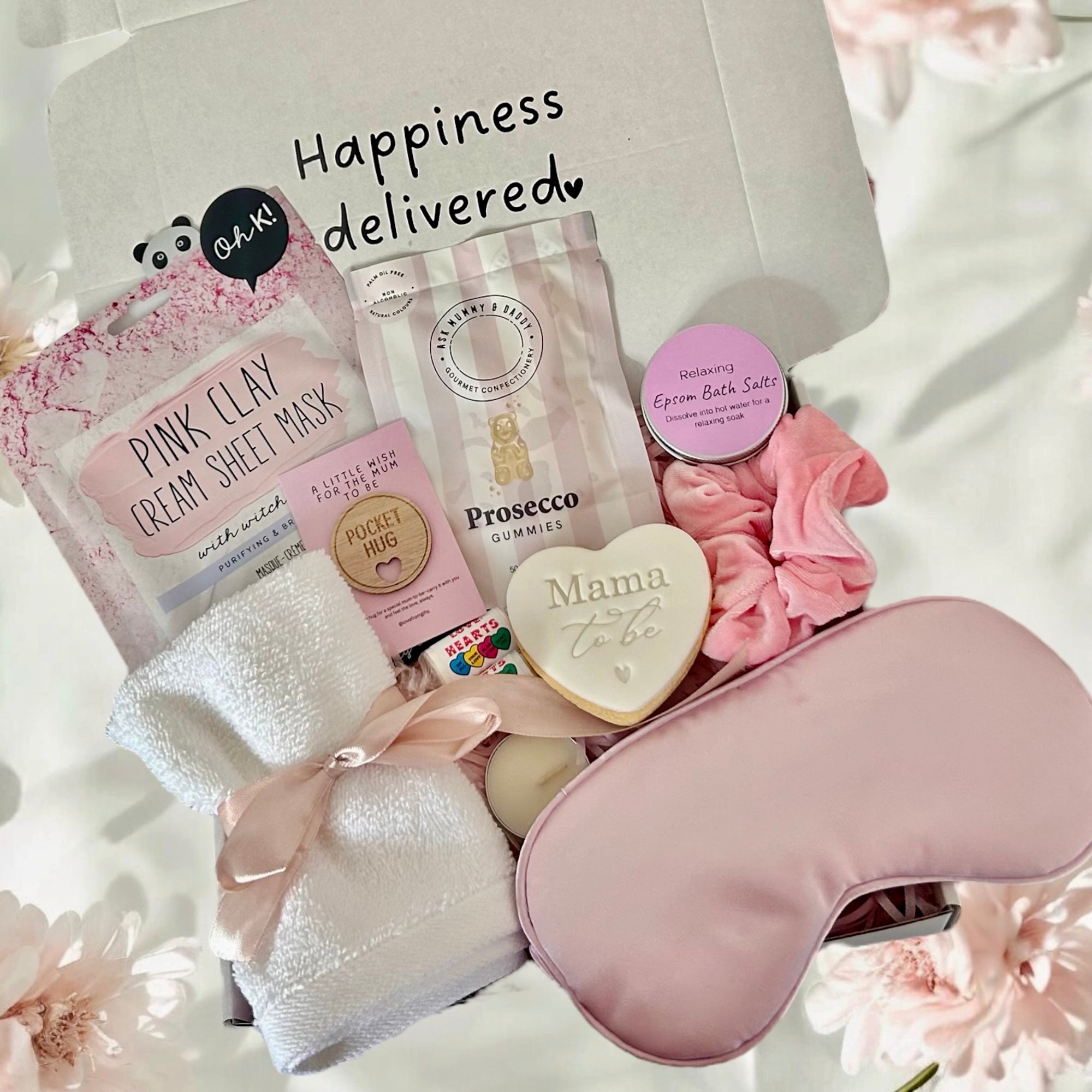 Mum-to-Be gift set including a relaxing face mask, delicious cookie, calming bath salts, and assorted treats, beautifully arranged in a cosy gift box.