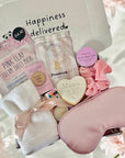 Mum-to-Be gift set including a relaxing face mask, delicious cookie, calming bath salts, and assorted treats, beautifully arranged in a cosy gift box.