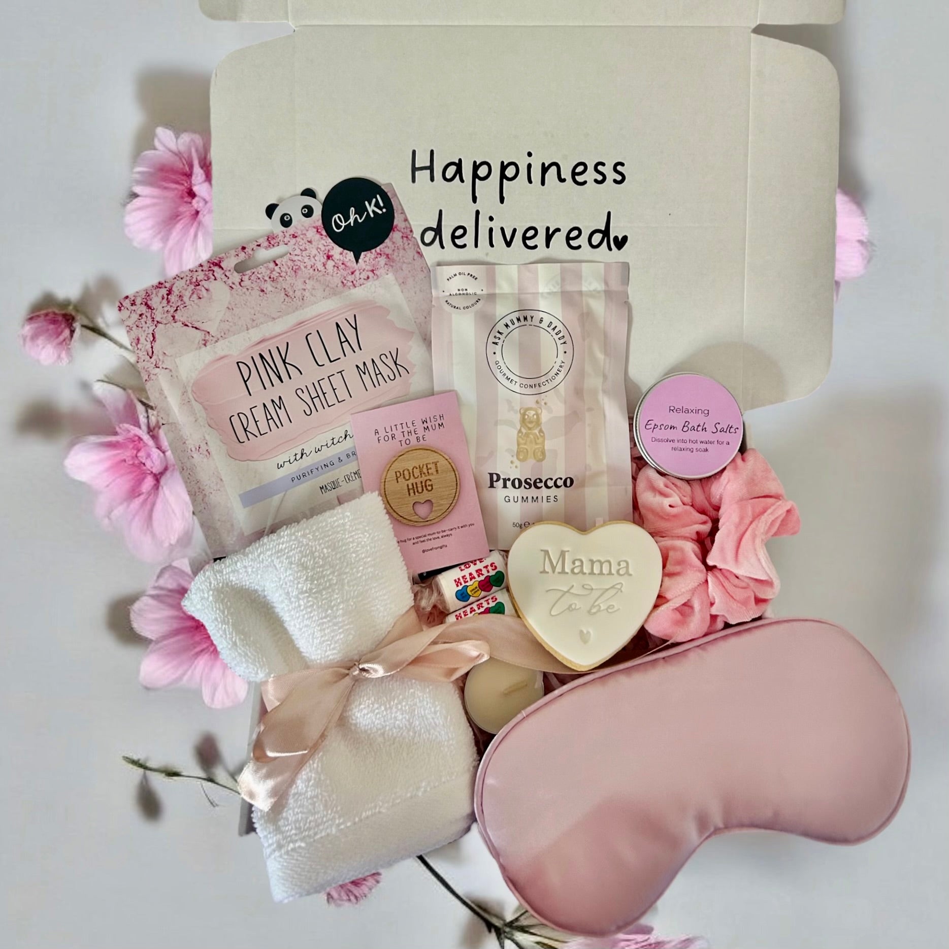 Mum-to-Be gift set including a relaxing face mask, delicious cookie, calming bath salts, and assorted treats, beautifully arranged in a cosy gift box.