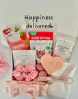 New Mum gift box featuring soothing face mask, indulgent cookie, calming bath salts, and assorted treats, thoughtfully curated to pamper and relax new mothers.