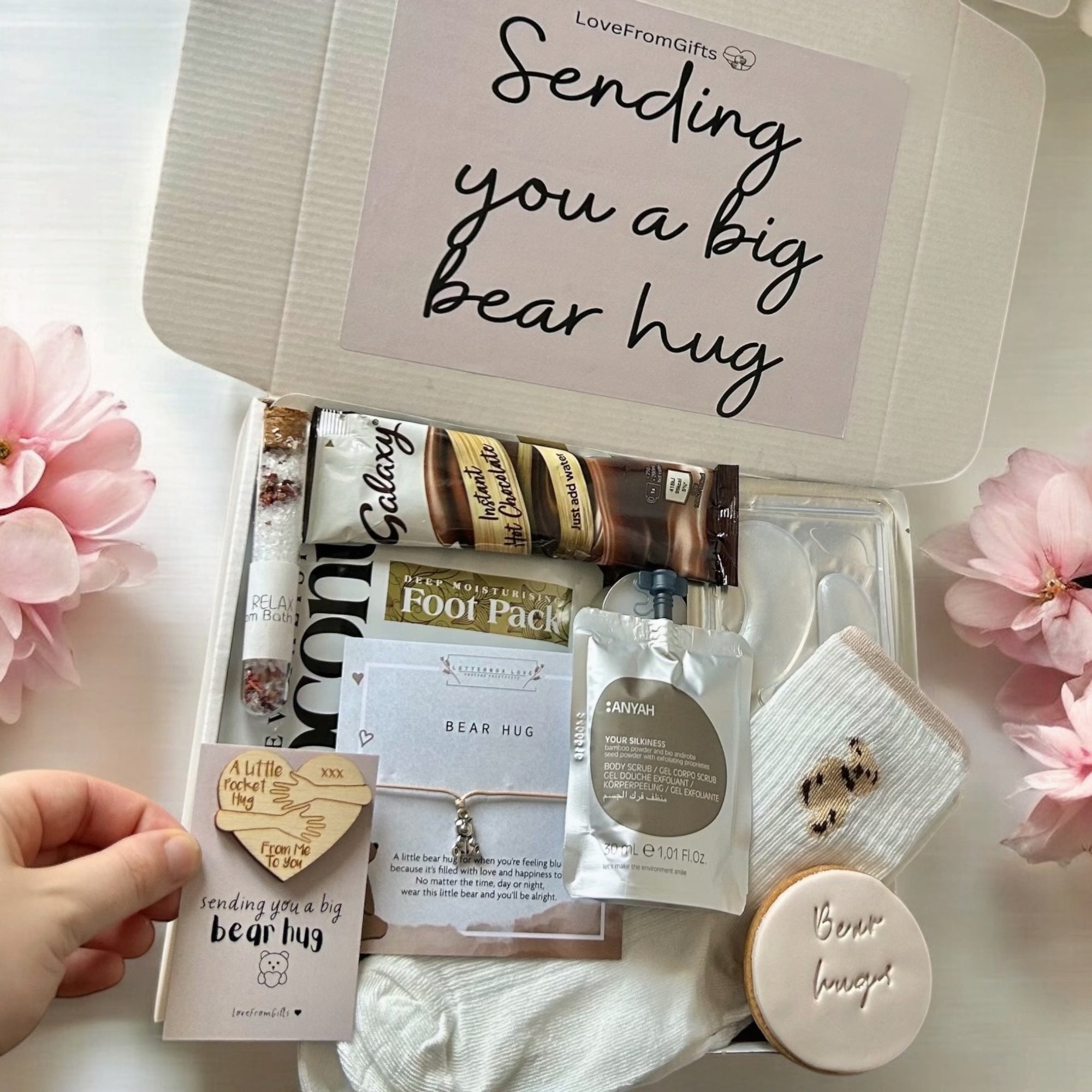 Sending Bear Hugs gift box with a soft teddy socks, comforting treats, and a thoughtful card, all arranged in a cosy package to show love and care.